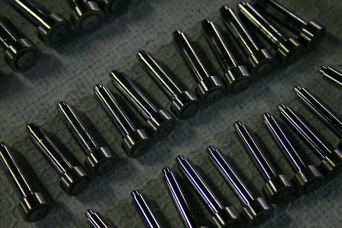 Rows of machined steel pins laid out for inspection