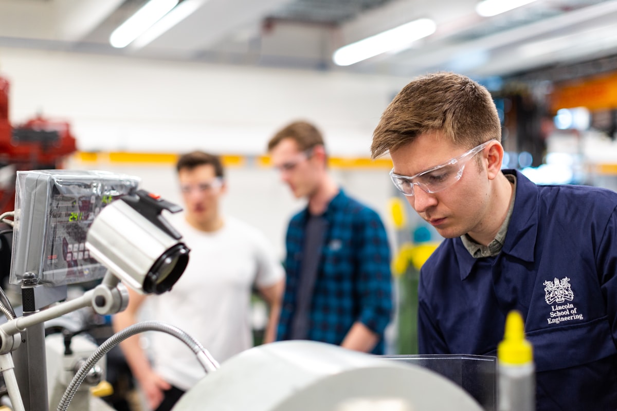 An engineering student working at a machine in a university workshop